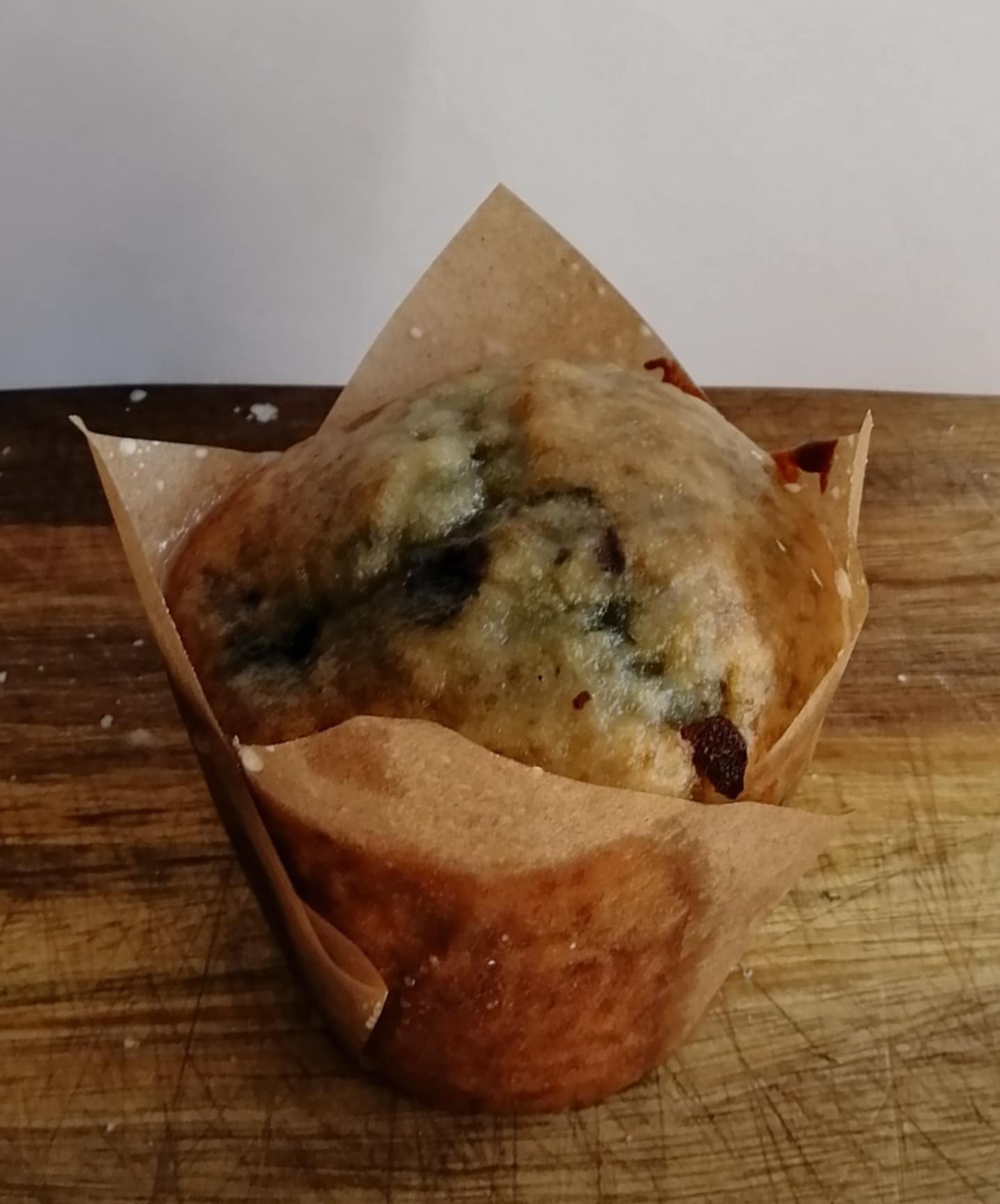 Lemon & Blueberry Muffin with a lemon glaze on a wooden board